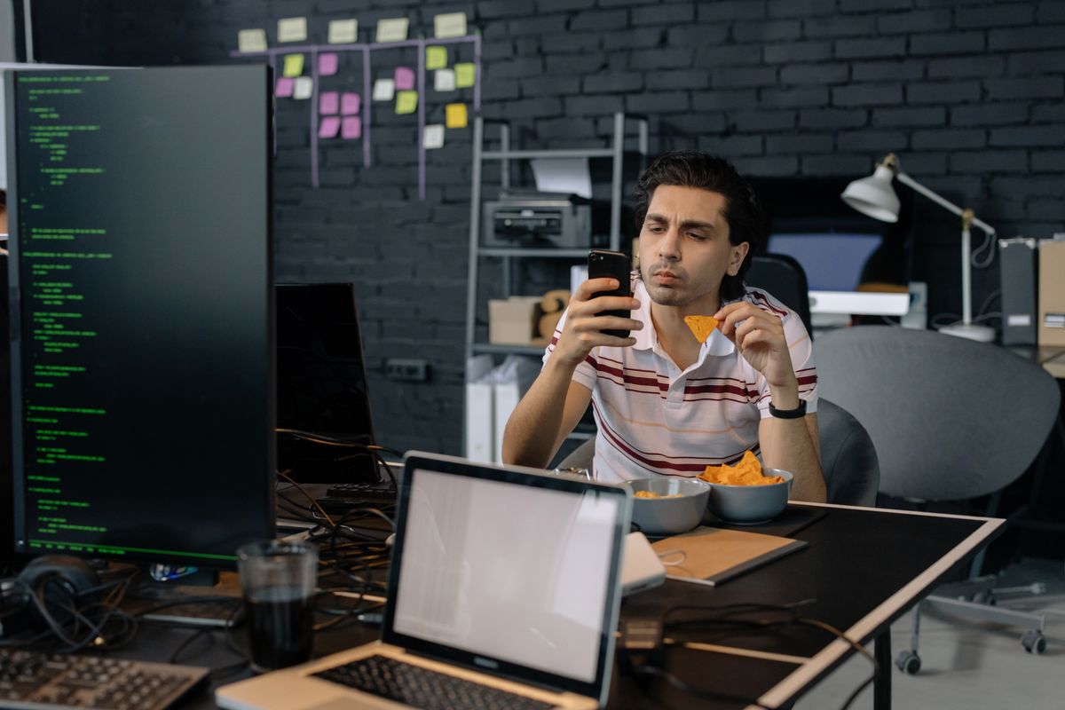 Engineer checking a smartphone at a tech studio